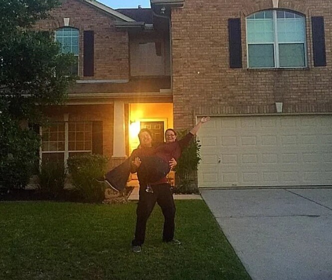 Liz and Sergio in front of their home