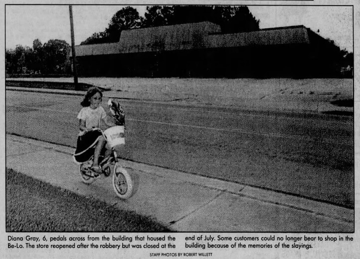 Girl on bike outside of former Be-Lo Grocery